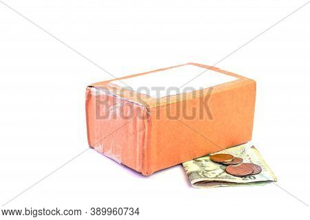 Parcel Post Box And Money Banknote Thai Baht On White, Money And Cardboard Box For Shipping Service 