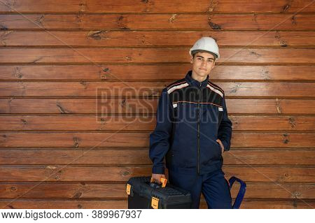 Image Of A Carpenter Or Cabinetmaker With A Set Of Tools On The Background Of A Wooden Wall. Joiner 