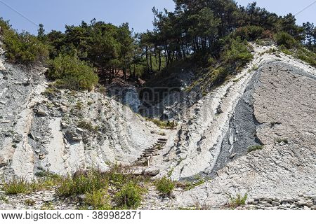 An Old Wooden Staircase And Massive White Rocks On A Wild Beach. The Path To The Camp Goes Through T