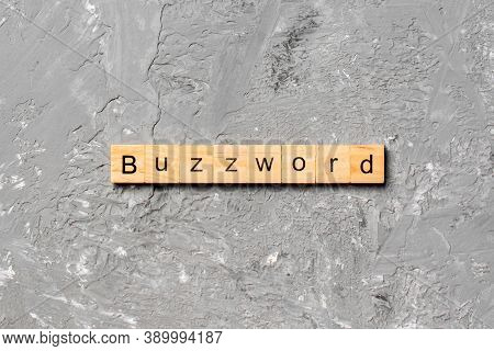Buzzword Word Written On Wood Block. Buzzword Text On Cement Table For Your Desing, Concept