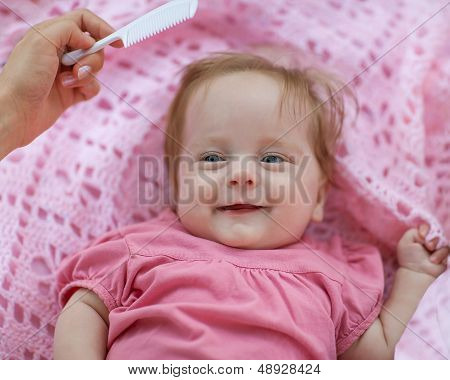 Mother Combing Red Hair Newborn Girl.