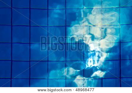 Reflection of sun and clouds in the pool.