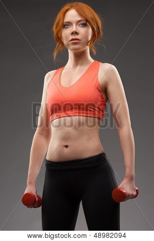woman exercising with dumbbells
