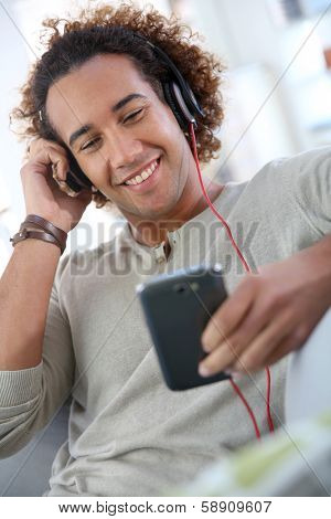 Cheerful attractive man listening to music 
