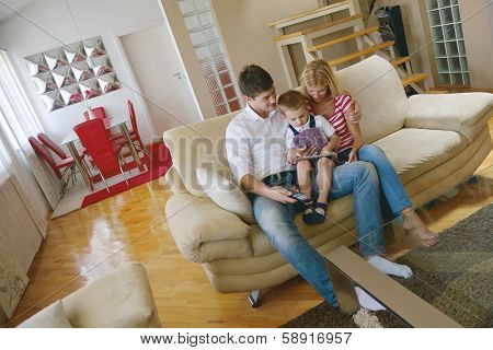 happy young family eating tasty pizza with cheesa and dring healthy and fresh orange juice