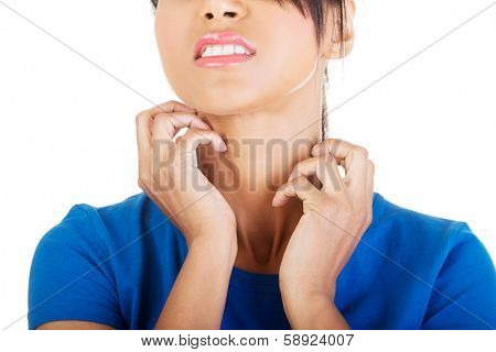 Young beautiful woman scratching her self. Isolated on white 