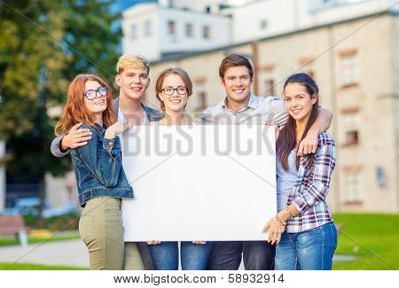 summer holidays, advertisement, education, campus and teenage concept - group of students or teenagers with white blank board