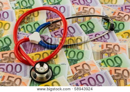stethoscope and euro bills. symbolic photo for healthcare costs and for health and medicine