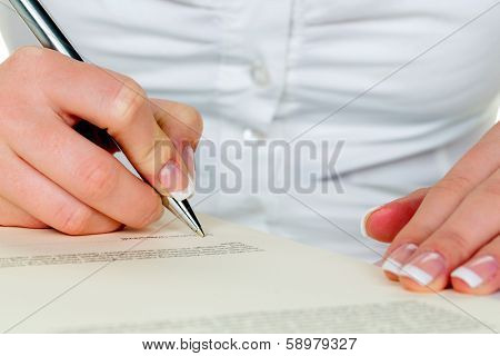 hand with fountain pen signing contract. sign woman while