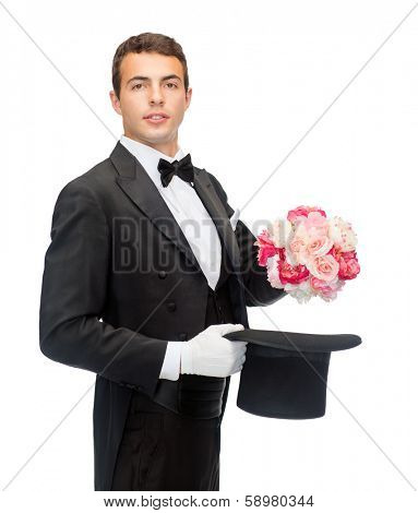 magic, performance, circus, show concept - magician taking out of top hat flower bouquet