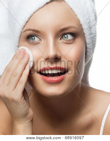 closeup portrait of attractive  caucasian smiling woman blond isolated on white studio shot lips toothy smile face head and shoulders l blue eyes cleaning face cotton disc