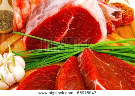 uncooked meat : raw fresh beef pork rib and fillet ready to cooking with garlic and green stuff over wood isolated on white background