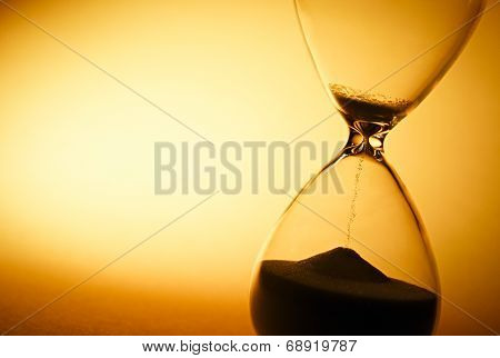 Sand Passing Through The Bulbs Of An Hourglass