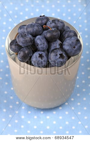 Blueberry in a bowl on blue dotted cloth