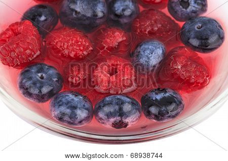 Blueberry and raspberry in a bowl isolated on white