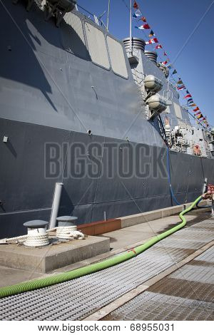 STATEN ISLAND, NY - MAY 25, 2014: The dock mooring bollards and gray hull of the guided-missile destroyer USS Cole (DDG 067) moored at Sullivans Piers for Fleet Week NY.