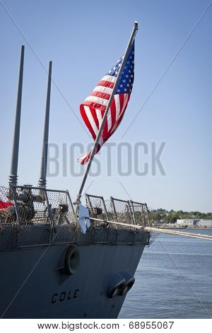 STATEN ISLAND, NY - MAY 25, 2014: The American flag flies from the stern of the guided-missile destroyer USS Cole (DDG 067) docked at Sullivans Piers during Fleet Week NY on May 25, 2014.