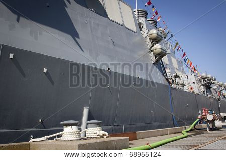 STATEN ISLAND, NY - MAY 25, 2014: The dock mooring bollards and gray hull of the guided-missile destroyer USS Cole (DDG 067) moored at Sullivans Piers for Fleet Week NY.