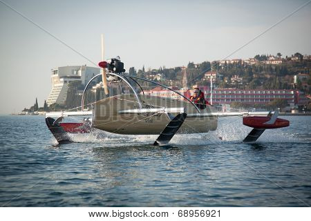 Portoroz, Slovenia - 6 May, 2014: Men riding a motorised vessel on foils in the sea.