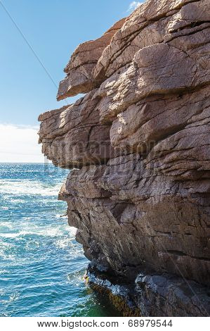 Rocky Cliffs Over Blue Sea