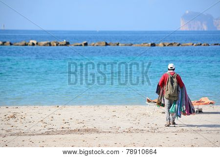 Seller Walking On The Beach In Alghero Shore