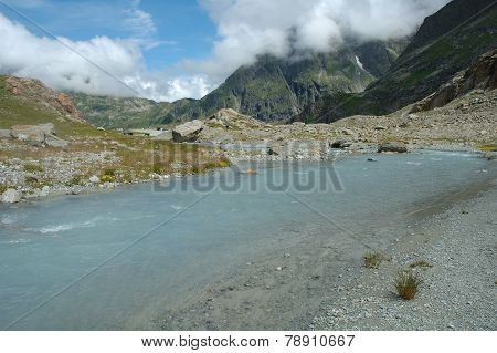 Gill In Valley Nearby Glacier In Alps In Switzerland