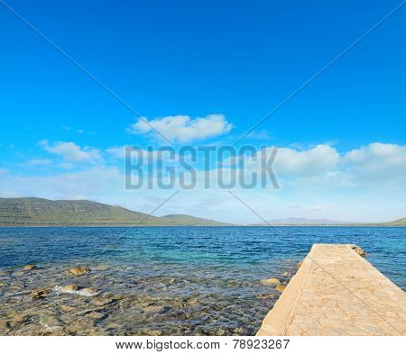 Rocky Pier On A Clear Day