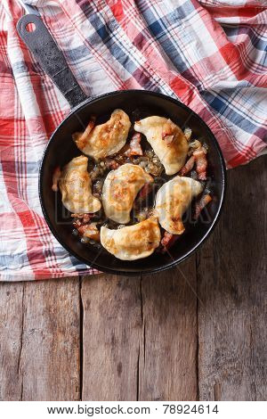 Fried Dumplings With Onion And Bacon In A Pan Vertical Top View