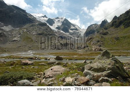 Rocks In Valley Nearby Glacier In Alps In Switzerland
