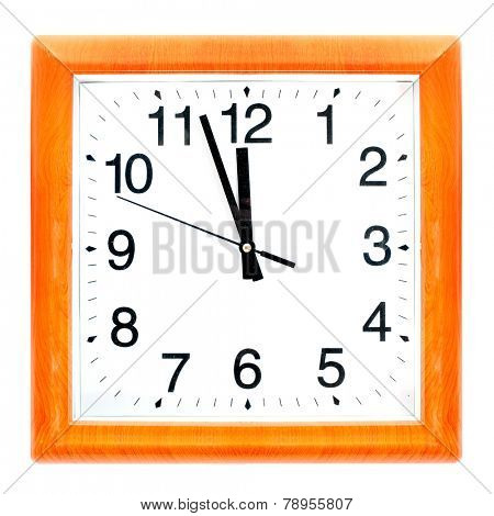 At the eleventh hour on a retro clock with wooden frame.