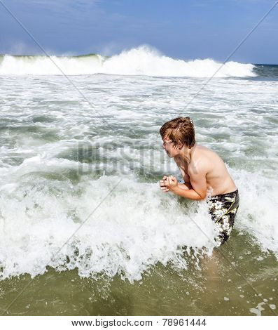 Boy Enjoys The Waves Of The Sea