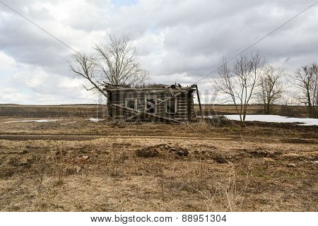 Destroyed wooden house in the deserted village