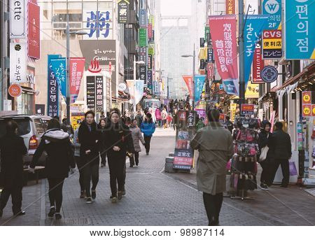Urban Scene With Many Unidentified People Walk Around Walking Street In Myeong-dong Market In Seoul,