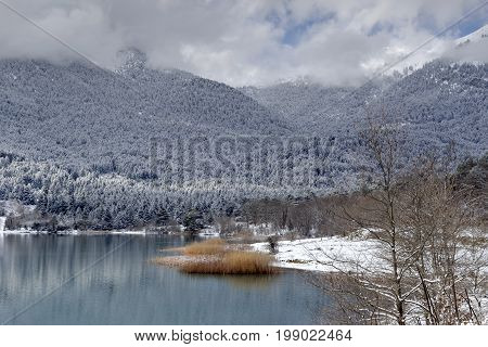 Lake in the mountains in winter on a sunny day (Greece, mountainous Corinthia)