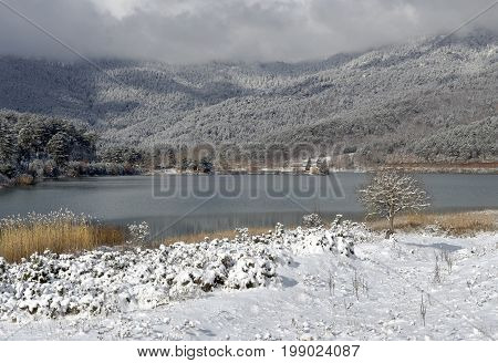 Lake in the mountains in winter on a sunny day (Greece, mountainous Corinthia)