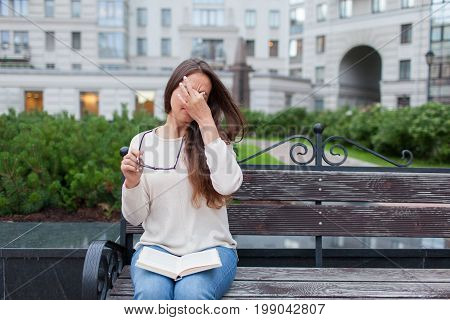 Closeup Portrait Of Attractive Female With Eyeglasses In Hand. Poor Young Girl Has Issues With Visio