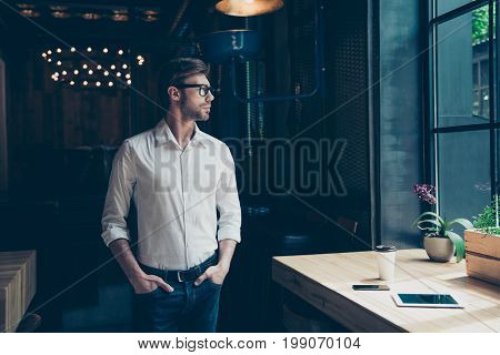 Young Well Dressed Entrepreneur At The Modern Office Is Looking At The Window, Well Dressed, Serious