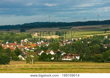 View of the small town of Neustadt (Marburg-Biedenkopf district in Hessen) the suburbs and surrounding agricultural land in the morning sun.