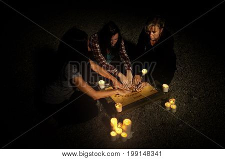 Woman spiritualists communicating with ghosts through spiritual board