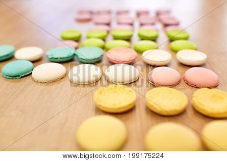cooking, confectionery and baking concept - macarons on table