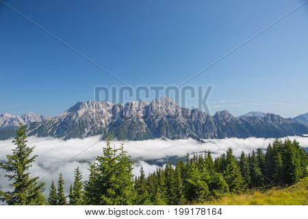Austrian Alps Salzburg Leogang. Blue Sky Morning Fog Beautiful Scenery Austrian Alps In Summer