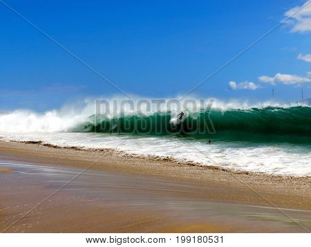Surfer Riding Wave on Dangerous Hawaiian Shorebreak