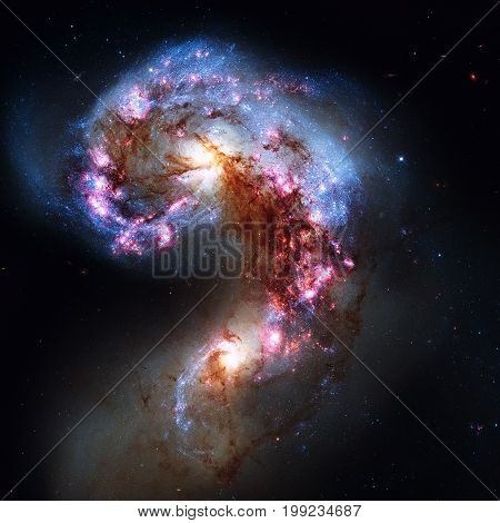 The Antennae Galaxies or NGC 4038 or NGC 4039 are undergoing a galactic collision. Located in the constellation Corvus. Retouched image. Elements of this image furnished by NASA.