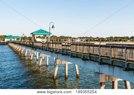 HAMPTON, VIRGINIA - JULY 9, 2017:  People on the 709-foot fishing pier at Buckroe Beach.  Originally the site of a plantation, Buckroe Beach now includes a beach, pier and public park.