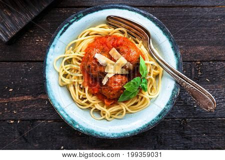 Itallian spaghetti and meatballs and parmegano for dinner, comfort food, close view.