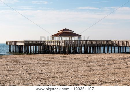 The wooden public viewing pier at Buckroe Beach in Hampton, Virginia.  It has a gazebo and a deck for non-fisherman to enjoy the view.