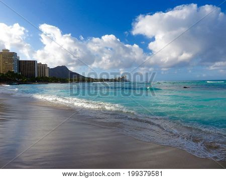 Sunrise on Waikiki Beach Overlooking Diamond Head Volcano, Skyline and Sea.