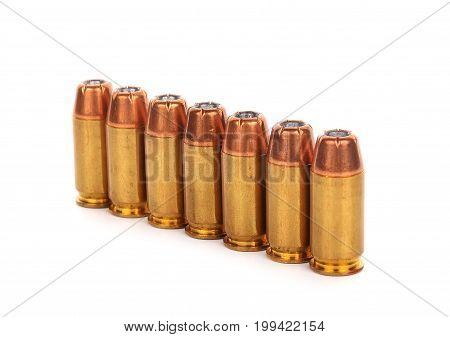 cartridges of .45 inch or 11mm pistols ammo bullets on white background
