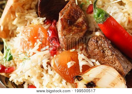 Close up of shah pilaff on big plate. National georgian cuisine, spicy rice with meat under lavash decorated chili pepper, dried apricot and grilled onion