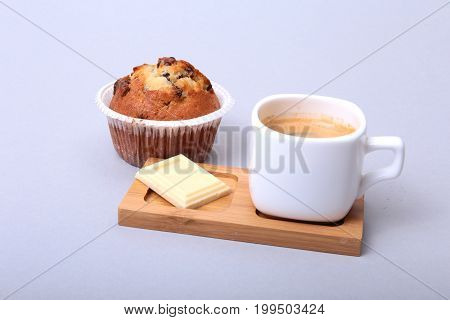 Classic espresso in white cup with homemade cake and chocolate on white background